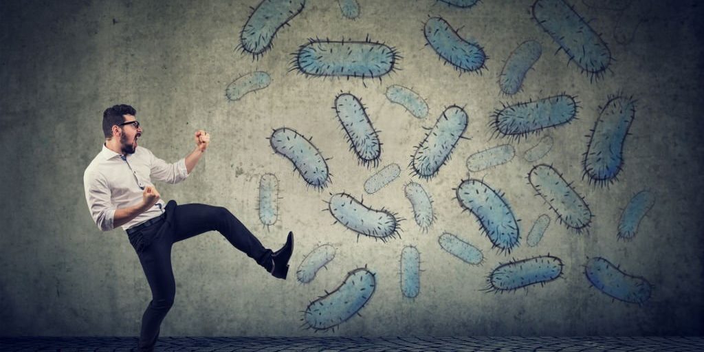 Man with healthy and strong immune system fighting kicks of viruses and bacteria in Salt Lake City, UT | Santosh Yoga Institute