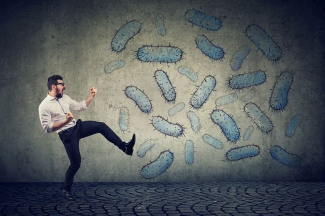 Man with healthy and strong immune system fighting kicks of viruses and bacteria in Salt Lake City, UT | Santosh Yoga Institute
