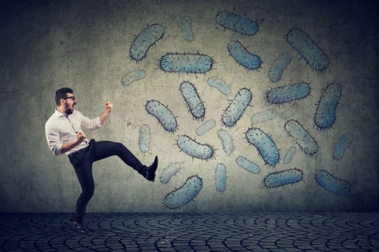 Man with healthy and strong immune system fighting kicks of viruses and bacteria in Salt Lake City, UT | Santosh Yoga Institute