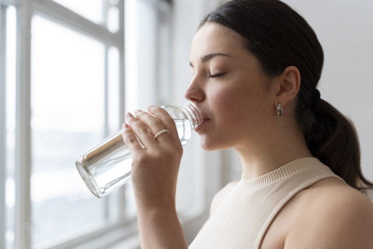 Young girl drinking water in Salt Lake City, UT | Santosh Yoga Institute