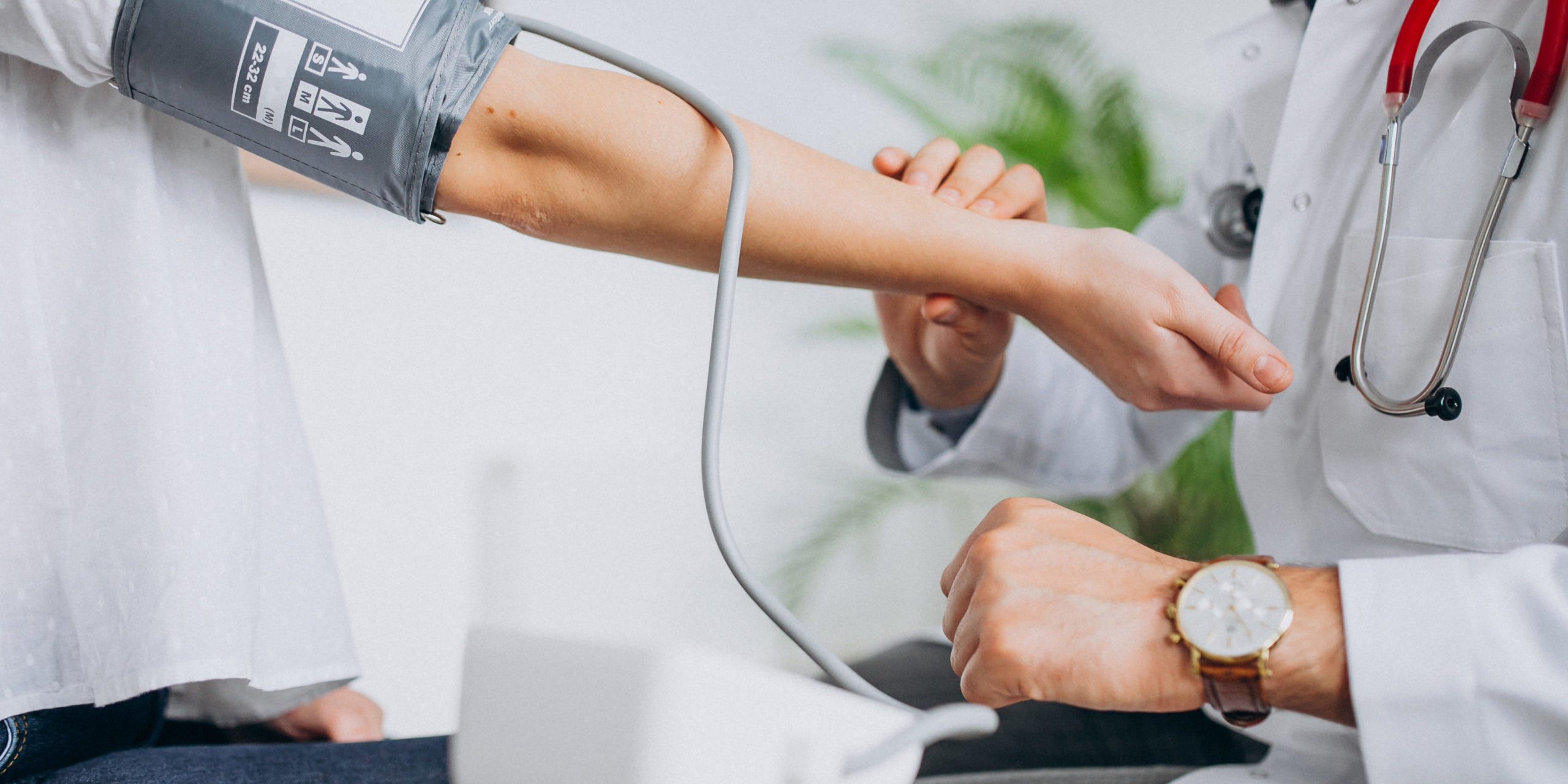 Doctor Checking Patient Blood-Pressure in Salt Lake City, UT | Santosh Yoga Institute