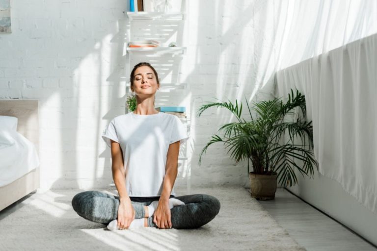 Relaxing closed eyes woman doing yoga at home in Salt Lake City, UT | Santosh Yoga Institute