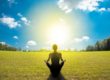 Young female sitting in beautiful garden doing meditation yoga in Salt Lake City, UT | Santosh Yoga Institute