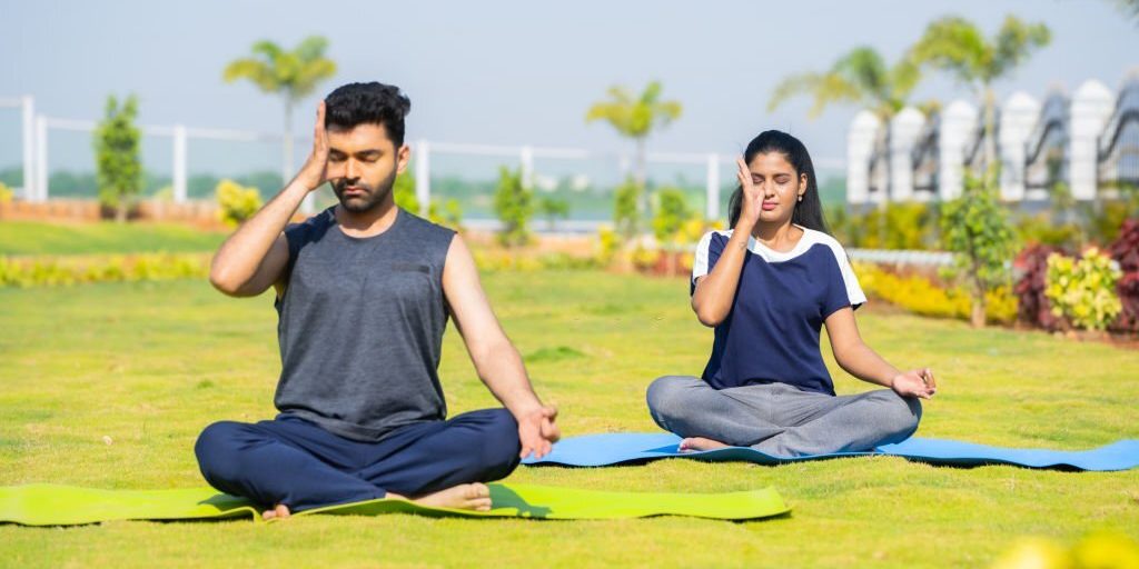 Young male & female performing Pranayama yoga in Salt Lake City, UT | Santosh Yoga Institute