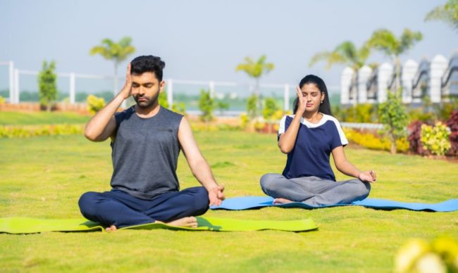 Young male & female performing Pranayama yoga in Salt Lake City, UT | Santosh Yoga Institute
