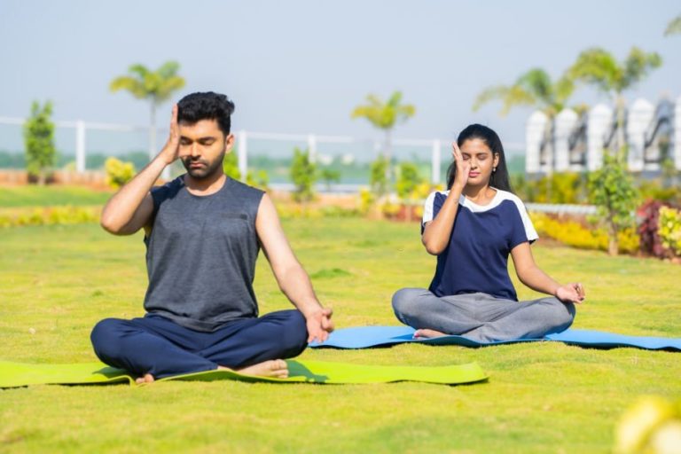 Young male & female performing Pranayama yoga in Salt Lake City, UT | Santosh Yoga Institute