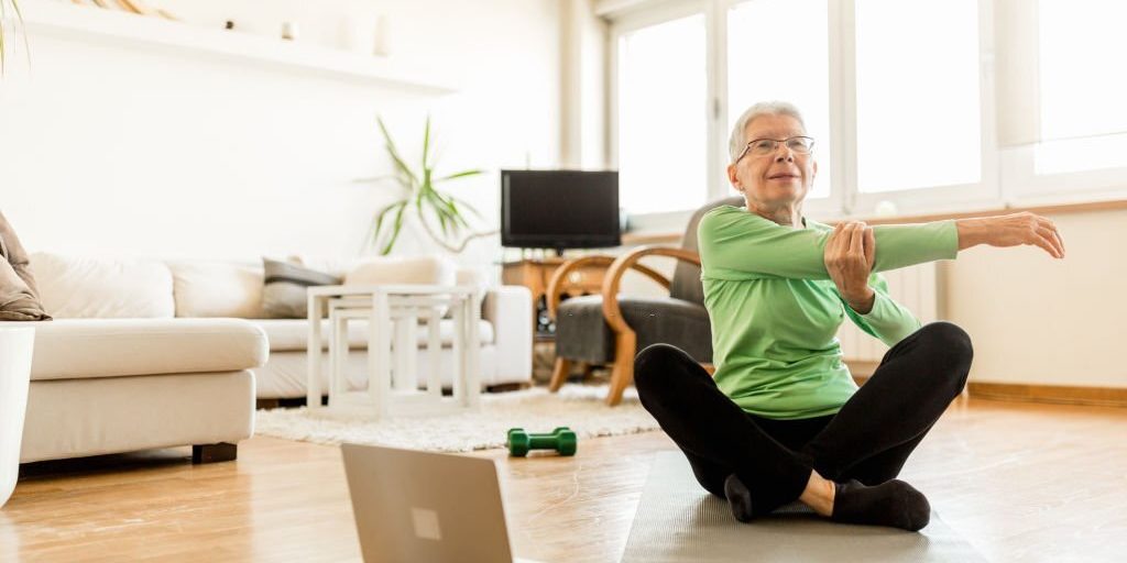 Senior woman doing yoga at home in Salt Lake City, UT | Santosh Yoga Institute
