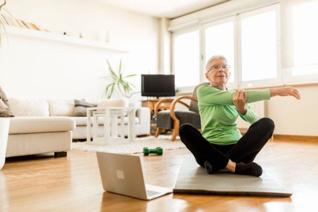 Senior woman doing yoga at home in Salt Lake City, UT | Santosh Yoga Institute
