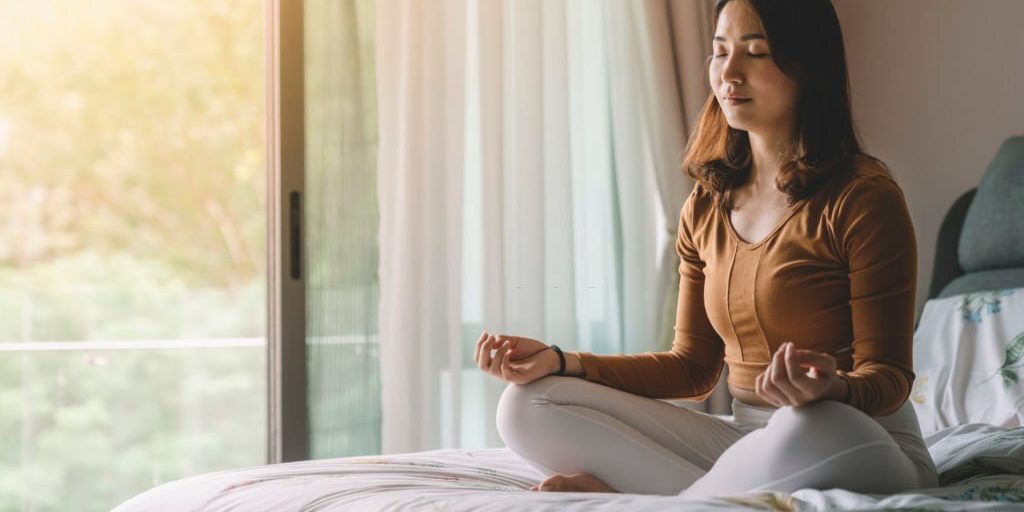 Young female doing meditation yoga in Salt Lake City, UT | Santosh Yoga Institute