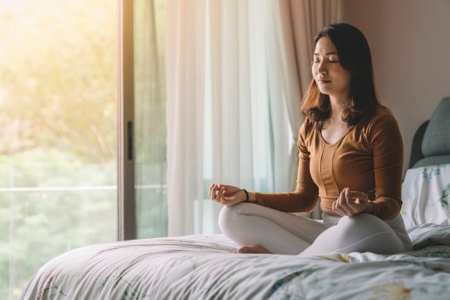 Young female doing meditation yoga in Salt Lake City, UT | Santosh Yoga Institute