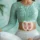 Woman practicing abdominal breathing in a seated yoga pose with highlighted digestive organs, representing deep diaphragmatic breathing benefits